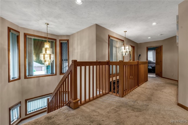 2160 Robert Dr, Niagara, NY 14304 - corridor with a chandelier, an upstairs landing, carpet, plenty of natural light, and recessed lighting