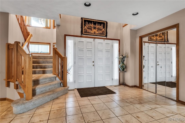 2160 Robert Dr, Niagara, NY 14304 - entryway with light tile patterned flooring and stairs