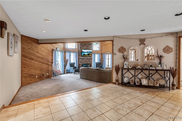2160 Robert Dr, Niagara, NY 14304 - living room with carpet floors, wooden walls, tile patterned flooring, a fireplace, and recessed lighting