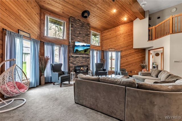 2160 Robert Dr, Niagara, NY 14304 - living room featuring a high ceiling, wood walls, carpet, a fireplace, and wood ceiling