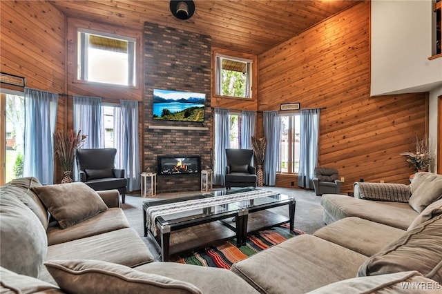 2160 Robert Dr, Niagara, NY 14304 - living area with wooden walls, high vaulted ceiling, wooden ceiling, a brick fireplace, and carpet flooring
