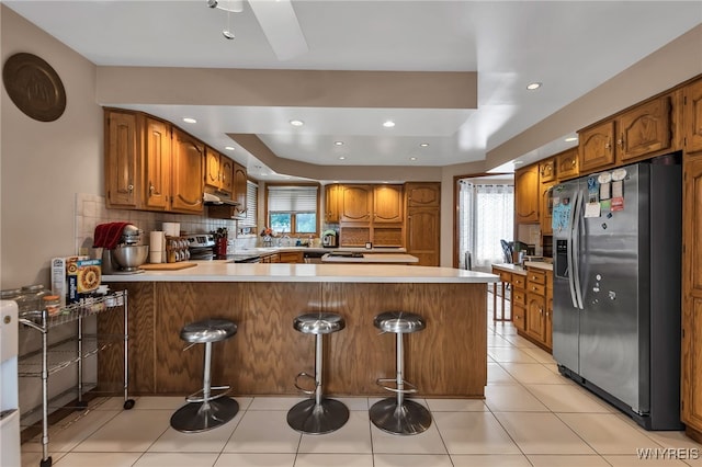 2160 Robert Dr, Niagara, NY 14304 - kitchen with appliances with stainless steel finishes, a peninsula, healthy amount of natural light, a raised ceiling, and recessed lighting