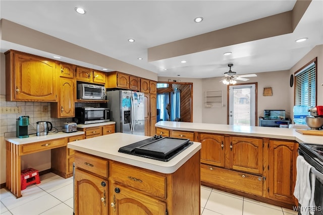 2160 Robert Dr, Niagara, NY 14304 - kitchen featuring appliances with stainless steel finishes, light tile patterned floors, a kitchen island, light countertops, and recessed lighting