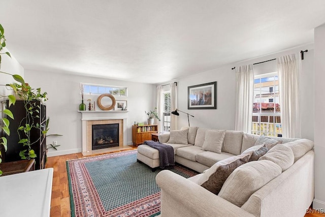 5418 Quamby Rd, Clay, NY 13041 - living room with a fireplace with flush hearth, plenty of natural light, and light wood-type flooring