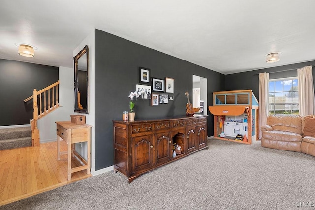 5418 Quamby Rd, Clay, NY 13041 - carpeted living room featuring stairs and wood finished floors