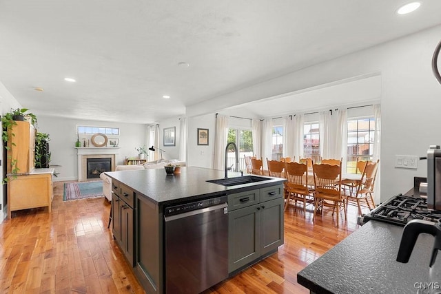 5418 Quamby Rd, Clay, NY 13041 - kitchen featuring stainless steel dishwasher, dark countertops, healthy amount of natural light, light wood-style floors, and recessed lighting