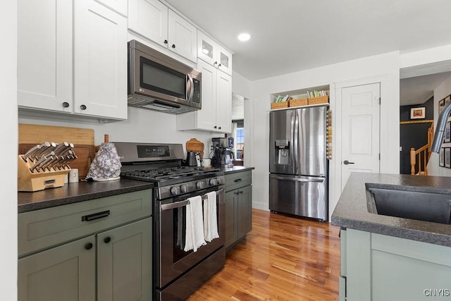 5418 Quamby Rd, Clay, NY 13041 - kitchen with appliances with stainless steel finishes, dark countertops, white cabinetry, and recessed lighting