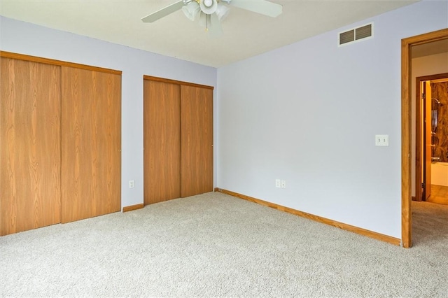 282 Troup St, Rochester, NY 14608 - unfurnished bedroom with carpet, two closets, and a ceiling fan