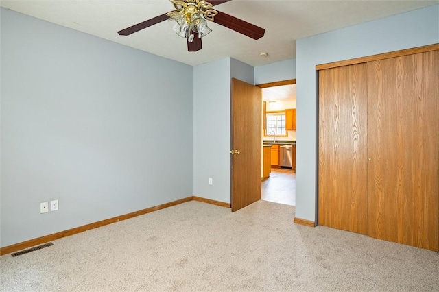 282 Troup St, Rochester, NY 14608 - unfurnished bedroom featuring light carpet, a closet, and ceiling fan