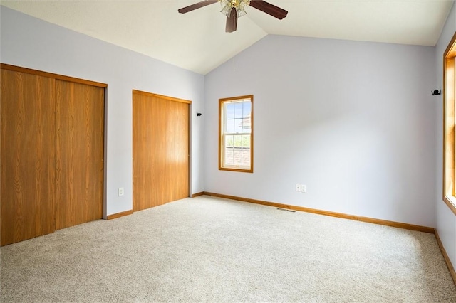 282 Troup St, Rochester, NY 14608 - unfurnished bedroom featuring multiple closets, carpet, lofted ceiling, and ceiling fan