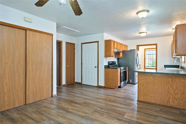 282 Troup St, Rochester, NY 14608 - kitchen with appliances with stainless steel finishes, under cabinet range hood, wood finished floors, ceiling fan, and brown cabinets