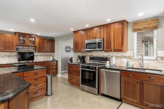 68 Dover Dr, West Seneca, NY 14224 - kitchen with stainless steel appliances, decorative backsplash, brown cabinets, recessed lighting, and dark stone countertops