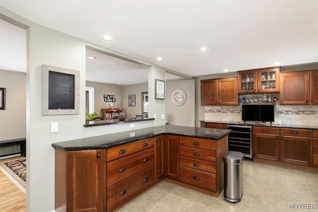 68 Dover Dr, West Seneca, NY 14224 - kitchen with wine cooler, backsplash, glass insert cabinets, dark stone counters, and recessed lighting