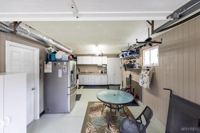 68 Dover Dr, West Seneca, NY 14224 - basement with stainless steel fridge, a garage, and wood walls