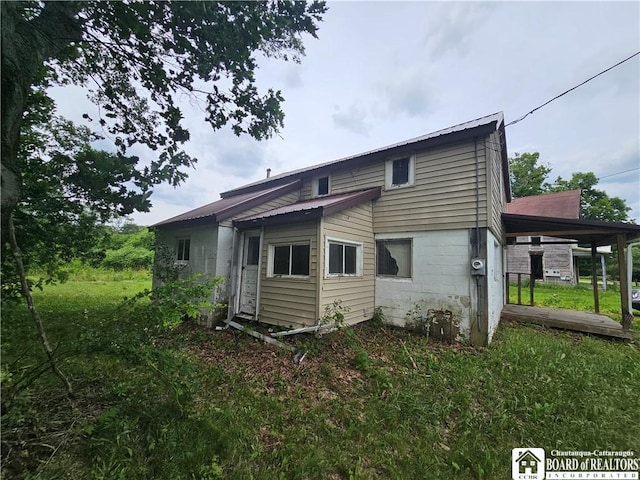 131 S Main St, Belfast, NY 14711 - rear view of property featuring a metal roof and a yard