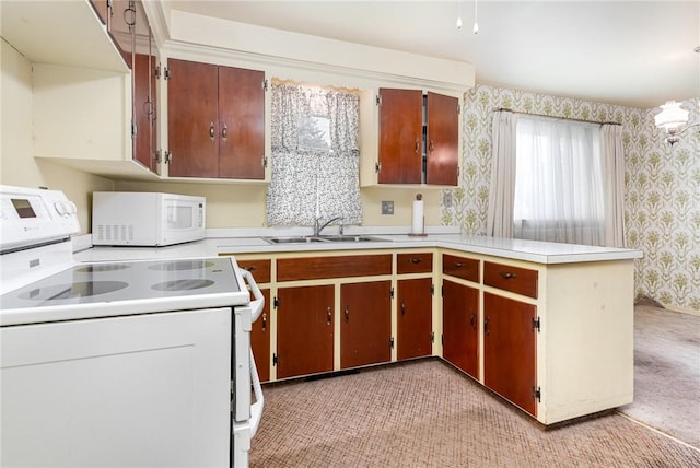 2622 Nichols St, Ogden, NY 14559 - kitchen with white appliances, wallpapered walls, light countertops, light colored carpet, and a peninsula