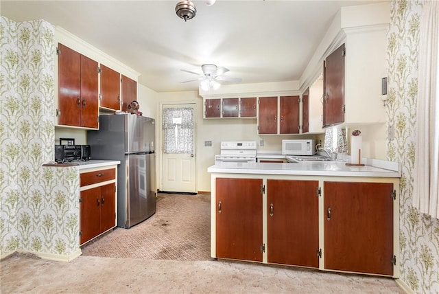 2622 Nichols St, Ogden, NY 14559 - kitchen featuring white appliances, a ceiling fan, light countertops, a peninsula, and wallpapered walls