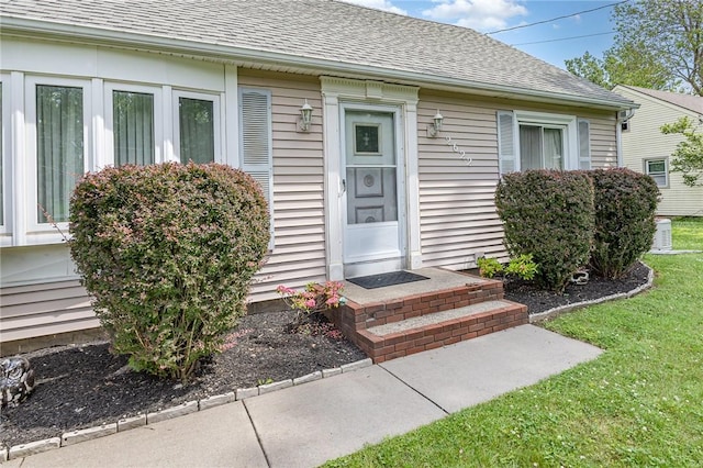 2622 Nichols St, Ogden, NY 14559 - view of exterior entry featuring a shingled roof and a yard