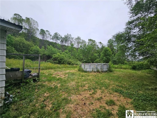 20 N Main St, Bolivar, NY 14715 - view of yard featuring an outdoor pool and a forest view