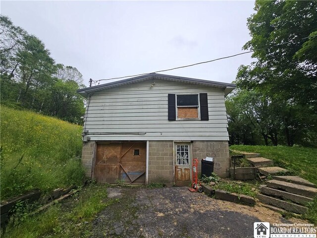 20 N Main St, Bolivar, NY 14715 - back of property with asphalt driveway