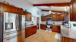 11 Overbrook Rd, Erwin, NY 14870 - kitchen featuring stainless steel appliances, light wood-type flooring, light stone counters, pendant lighting, and brown cabinets