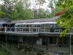 11 Overbrook Rd, Erwin, NY 14870 - back of property featuring a sunroom, a wooden deck, and a patio