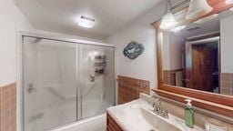 11 Overbrook Rd, Erwin, NY 14870 - full bathroom featuring vanity, a shower with shower door, and a wainscoted wall