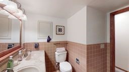 11 Overbrook Rd, Erwin, NY 14870 - bathroom featuring tile walls, wainscoting, and double vanity