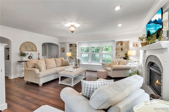 2846 Amsdell Rd, Hamburg, NY 14075 - living room featuring arched walkways, crown molding, a glass covered fireplace, dark wood finished floors, and built in shelves
