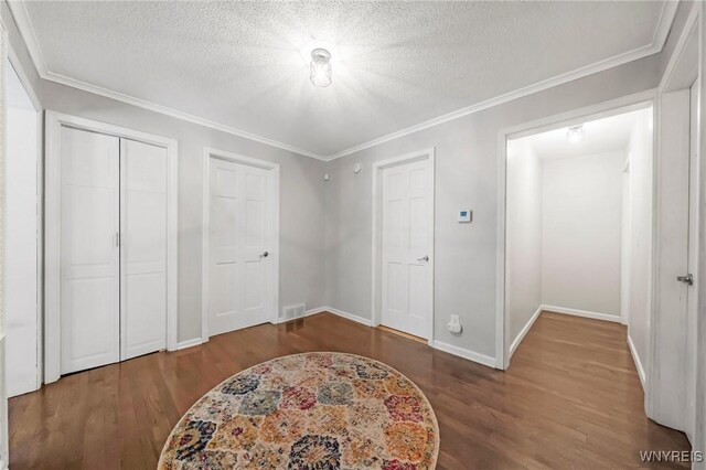 34 Wainwright Rd, Cheektowaga, NY 14215 - unfurnished bedroom with wood finished floors, a textured ceiling, and ornamental molding