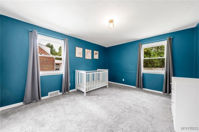 34 Wainwright Rd, Cheektowaga, NY 14215 - unfurnished bedroom featuring carpet and a crib