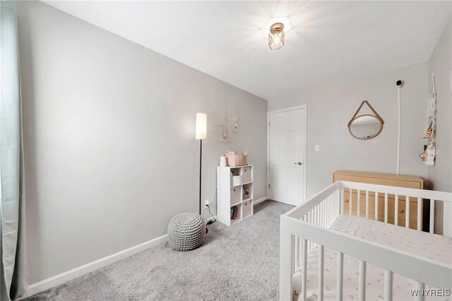 34 Wainwright Rd, Cheektowaga, NY 14215 - carpeted bedroom featuring baseboards and a crib