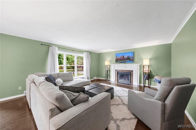 34 Wainwright Rd, Cheektowaga, NY 14215 - living room with dark wood finished floors, a tiled fireplace, and a textured ceiling
