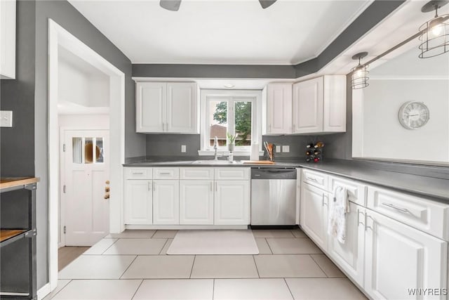 34 Wainwright Rd, Cheektowaga, NY 14215 - kitchen with dishwasher, white cabinets, ornamental molding, light tile patterned floors, and dark countertops