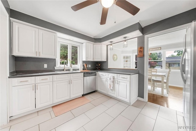 34 Wainwright Rd, Cheektowaga, NY 14215 - kitchen featuring stainless steel appliances, dark countertops, white cabinetry, a ceiling fan, and light tile patterned floors