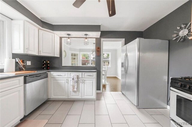 34 Wainwright Rd, Cheektowaga, NY 14215 - kitchen with stainless steel appliances, a ceiling fan, white cabinetry, dark countertops, and light tile patterned floors