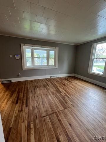 232 Hall Ave, Syracuse, NY 13205 - empty room featuring healthy amount of natural light, wood finished floors, and ornamental molding