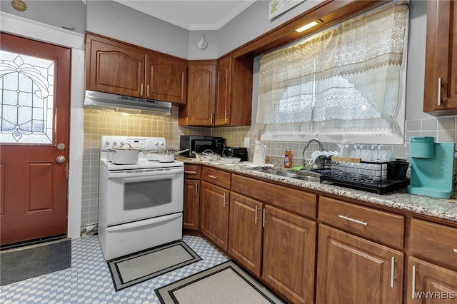 549 15th St, Niagara Falls, NY 14301 - kitchen with under cabinet range hood, white range with electric stovetop, ornamental molding, light floors, and brown cabinetry