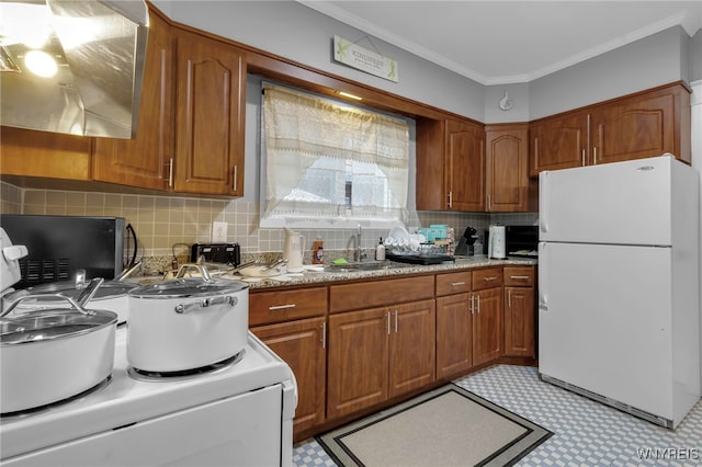 549 15th St, Niagara Falls, NY 14301 - kitchen featuring freestanding refrigerator, brown cabinetry, ornamental molding, decorative backsplash, and wall chimney exhaust hood