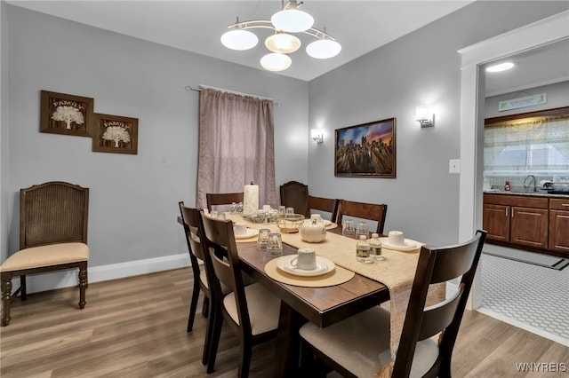 549 15th St, Niagara Falls, NY 14301 - dining space with light wood-style floors and a chandelier