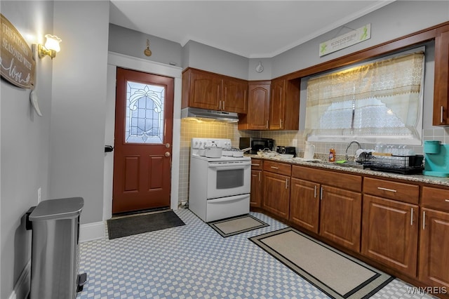 549 15th St, Niagara Falls, NY 14301 - kitchen with white electric range oven, under cabinet range hood, decorative backsplash, light flooring, and brown cabinetry