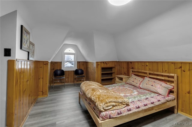 549 15th St, Niagara Falls, NY 14301 - bedroom with lofted ceiling, wood finished floors, wood walls, and wainscoting