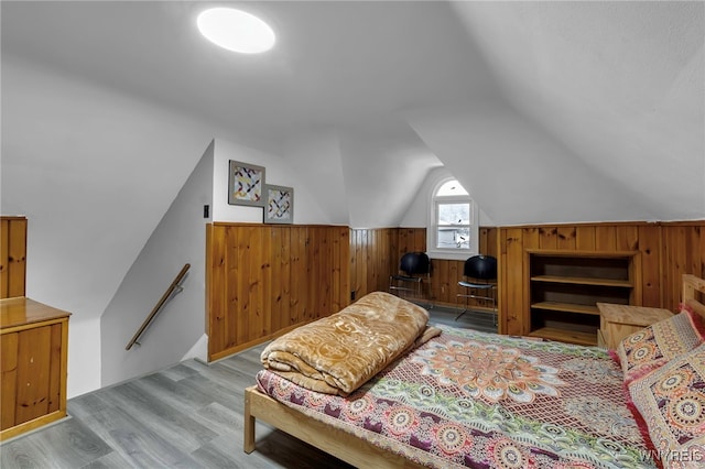 549 15th St, Niagara Falls, NY 14301 - bedroom featuring wooden walls, vaulted ceiling, and wood finished floors