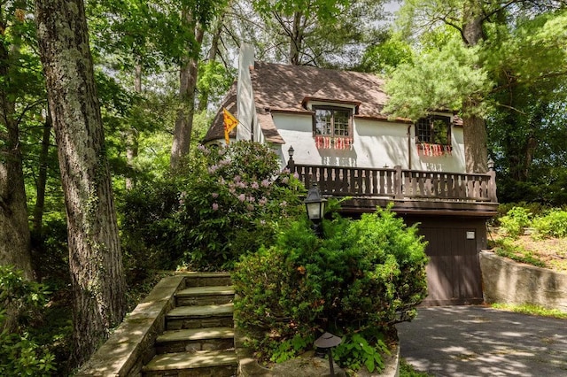 320 Glen Ave, Elmira, NY 14905 - tudor-style house with a chimney and stucco siding