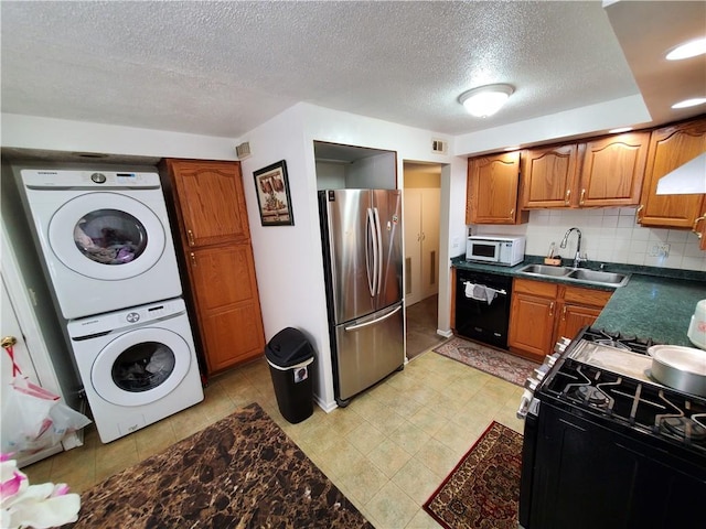 56 Canasta Rd, Greece, NY 14615 - kitchen with freestanding refrigerator, stacked washer and clothes dryer, white microwave, black dishwasher, and gas range