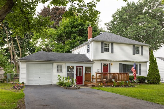 387 Brandon Rd, Irondequoit, NY 14622 - colonial home featuring a chimney, a garage, a deck, and driveway