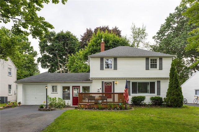 387 Brandon Rd, Irondequoit, NY 14622 - colonial home with a garage, driveway, a chimney, and a front lawn
