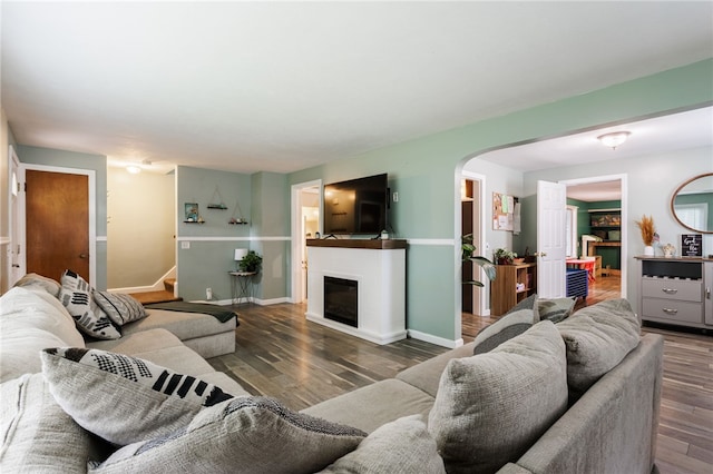 387 Brandon Rd, Irondequoit, NY 14622 - living room featuring arched walkways, wood finished floors, and a glass covered fireplace