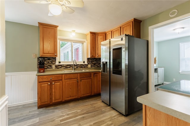 387 Brandon Rd, Irondequoit, NY 14622 - kitchen featuring stainless steel fridge, ceiling fan, light wood-type flooring, wainscoting, and healthy amount of natural light