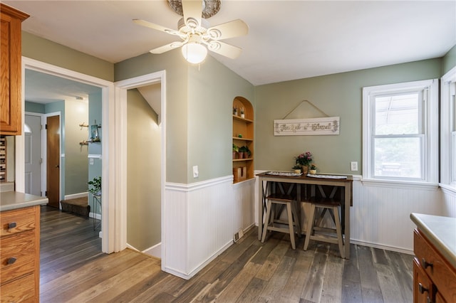 387 Brandon Rd, Irondequoit, NY 14622 - dining area with a wainscoted wall, dark wood-type flooring, and ceiling fan
